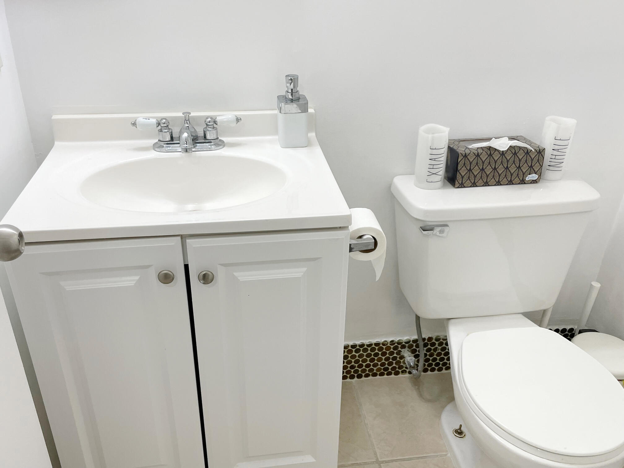 171 Suffolk F, Unit 171 Boca Raton, FL 33434 - Photo 12 of 21 a bathroom with a sink a toilet and a mirror