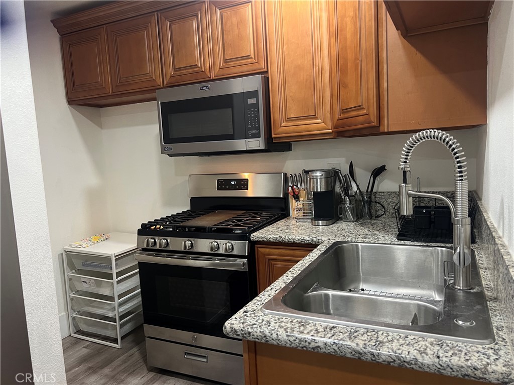 1331 Sao Paulo Avenue Placentia, CA 92870 - Photo 12 of 18 a kitchen with granite countertop a stove top oven microwave and cabinets