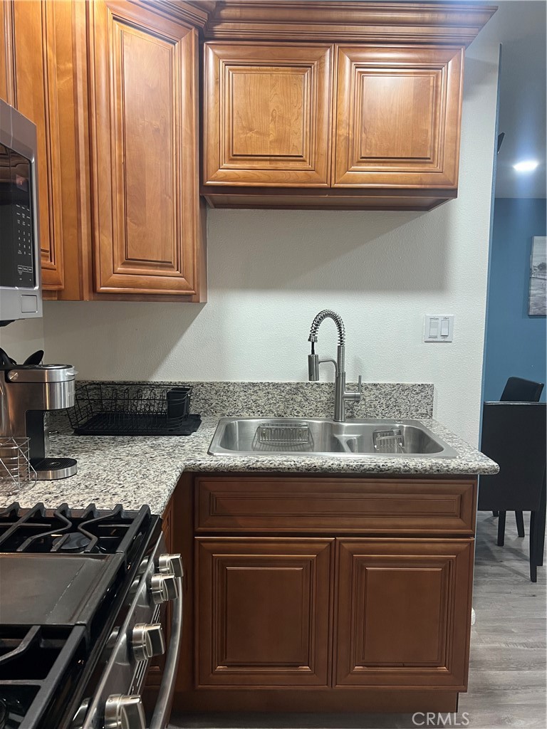 1331 Sao Paulo Avenue Placentia, CA 92870 - Photo 13 of 18 a kitchen with granite countertop a stove and a sink