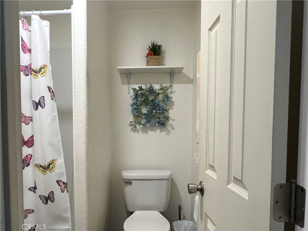 1331 Sao Paulo Avenue Placentia, CA 92870 - Photo 18 of 18 a bathroom with a toilet and a shower curtain