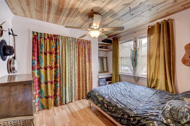 a bedroom with a bed and a large window