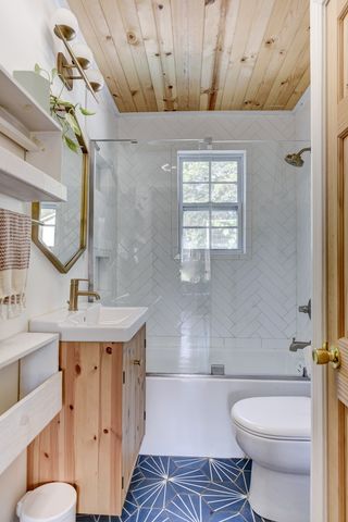 a bathroom with a granite countertop toilet sink and mirror