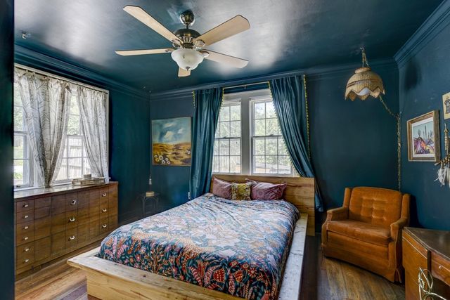 a bedroom with a bed dresser and a window