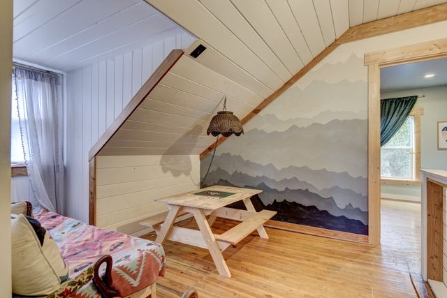 a view of a balcony with furniture and floor to ceiling window
