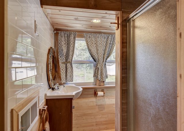 a bathroom with a sink a mirror and window