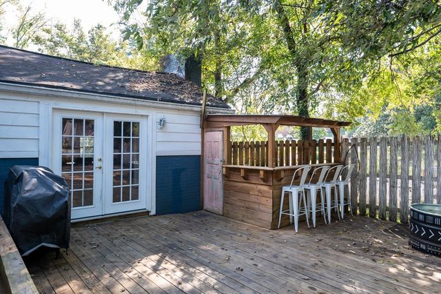 a view of a backyard with a large window and wooden fence
