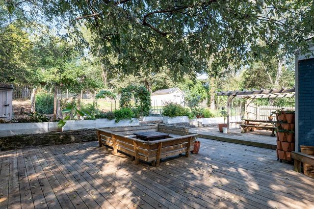 a backyard of a house with barbeque oven and outdoor seating