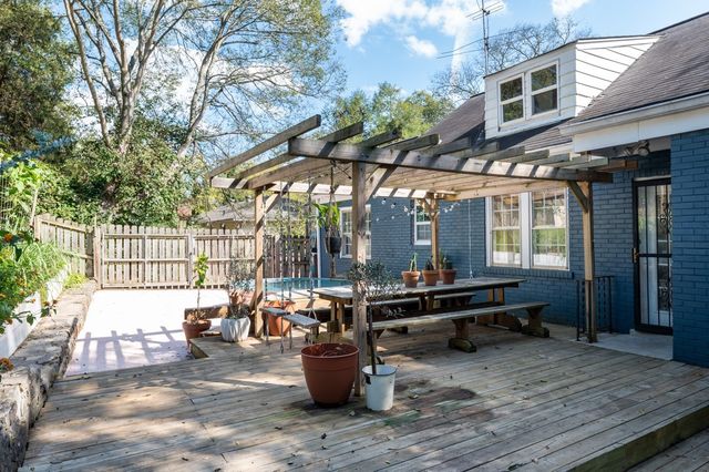 a view of a chairs and table in backyard of the house