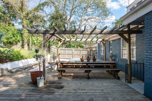 a backyard of a house with barbeque oven table and chairs