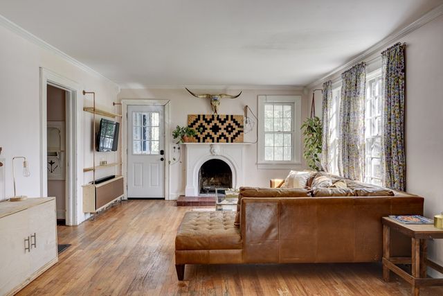 a living room with furniture and a fireplace