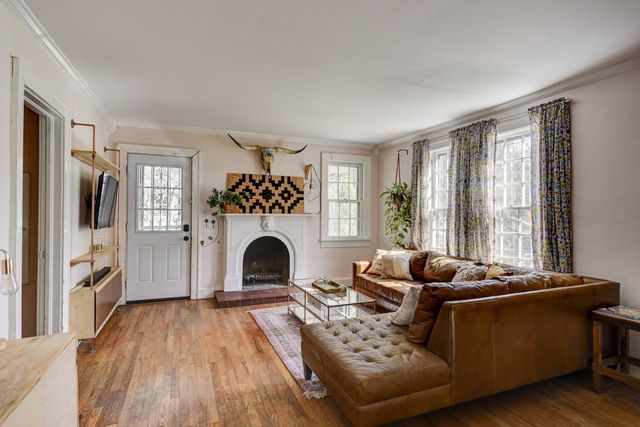 a living room with furniture and a fireplace