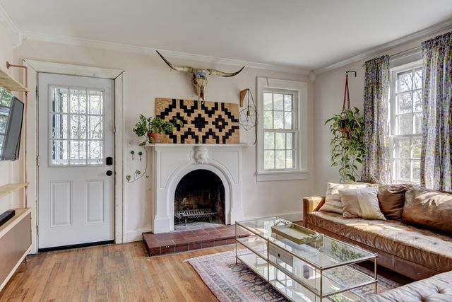 a living room with furniture and a fireplace
