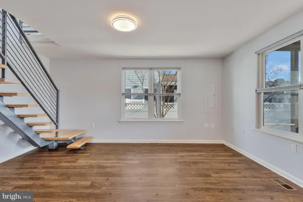 a living room with furniture and a dining table with kitchen view