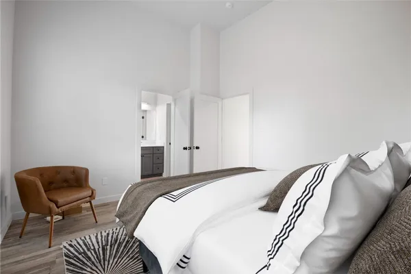 a bedroom with a bed and a chair