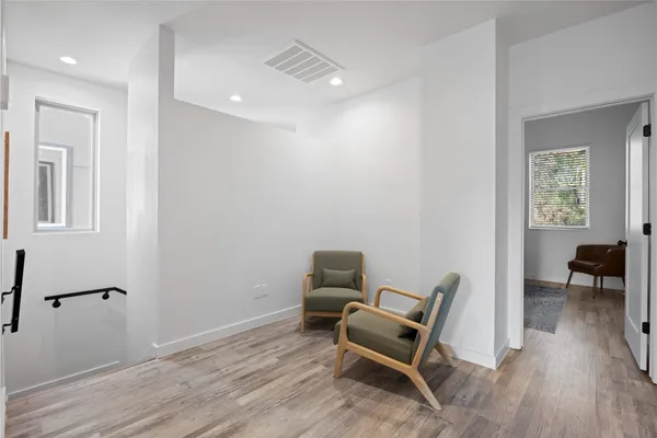 a work room with furniture and wooden floor