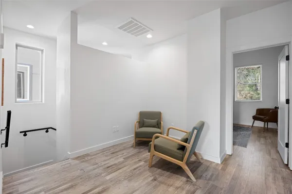 a work room with furniture and wooden floor