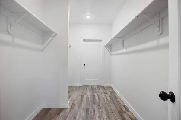 a view of a room with wooden floor