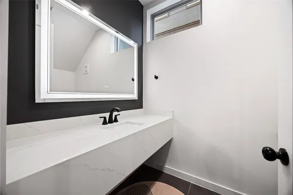 a bathroom with a sink and a mirror