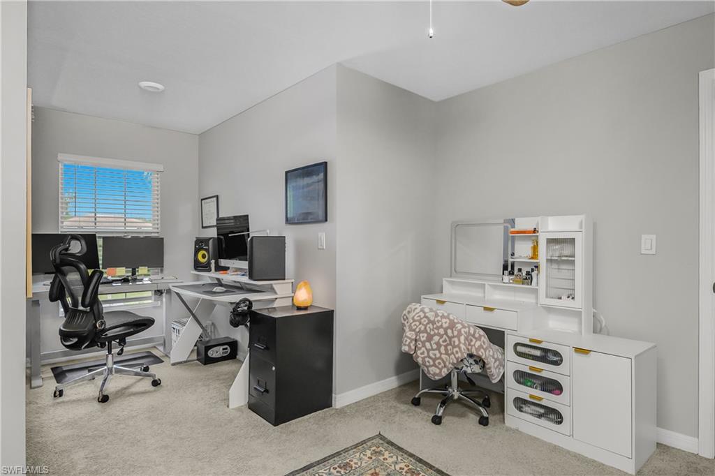 15436 Wildflower Circle Naples, FL 34119 - Photo 23 of 42 Home office featuring light carpet and a ceiling fan