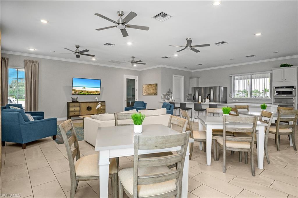 15436 Wildflower Circle Naples, FL 34119 - Photo 28 of 42 Dining room featuring light tile patterned flooring, ornamental molding, and recessed lighting