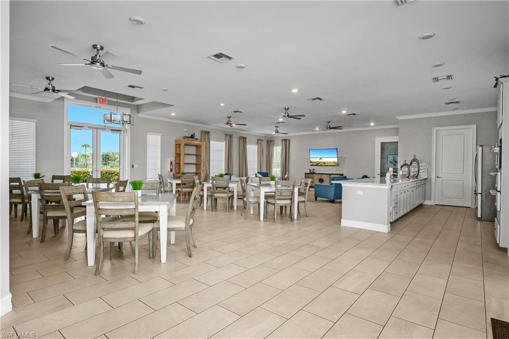 15436 Wildflower Circle Naples, FL 34119 - Photo 30 of 42 Dining area with crown molding, plenty of natural light, and ceiling fan