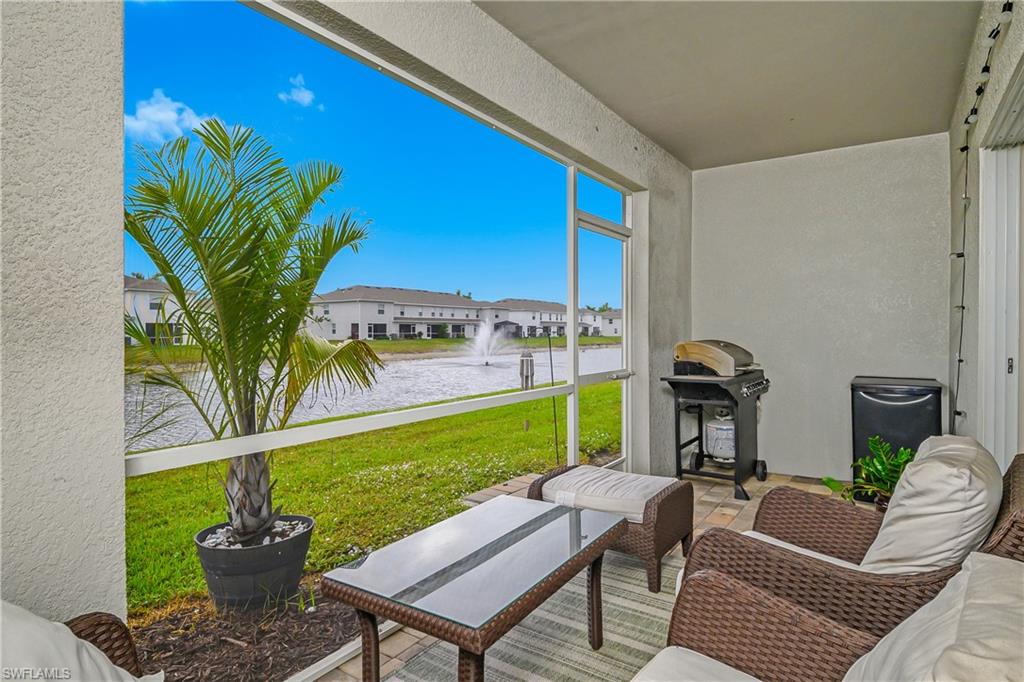 15436 Wildflower Circle Naples, FL 34119 - Photo 6 of 42 View of patio featuring a water view, area for grilling, and a sunroom