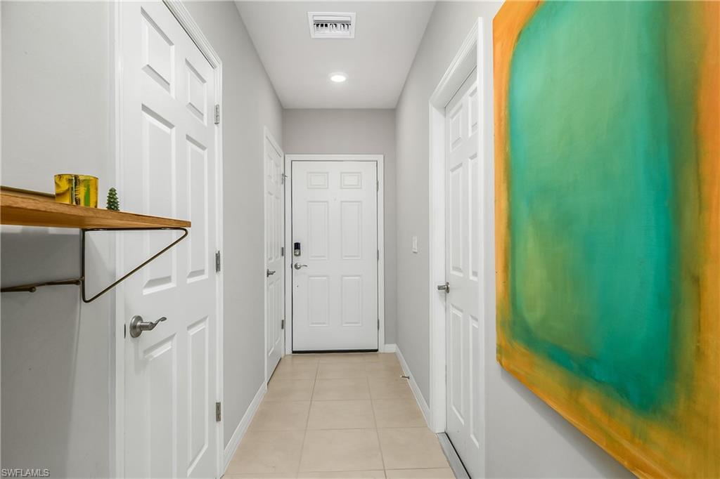 15436 Wildflower Circle Naples, FL 34119 - Photo 9 of 42 Doorway with tile patterned flooring and recessed lighting