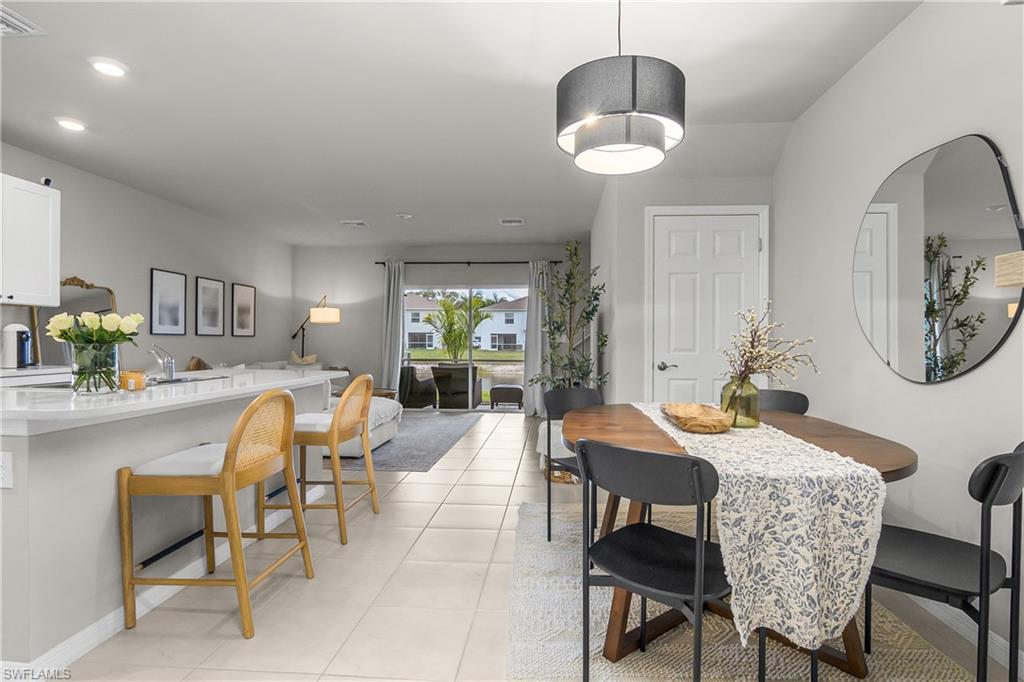 15436 Wildflower Circle Naples, FL 34119 - Photo 10 of 42 Dining area with light tile patterned floors and baseboards