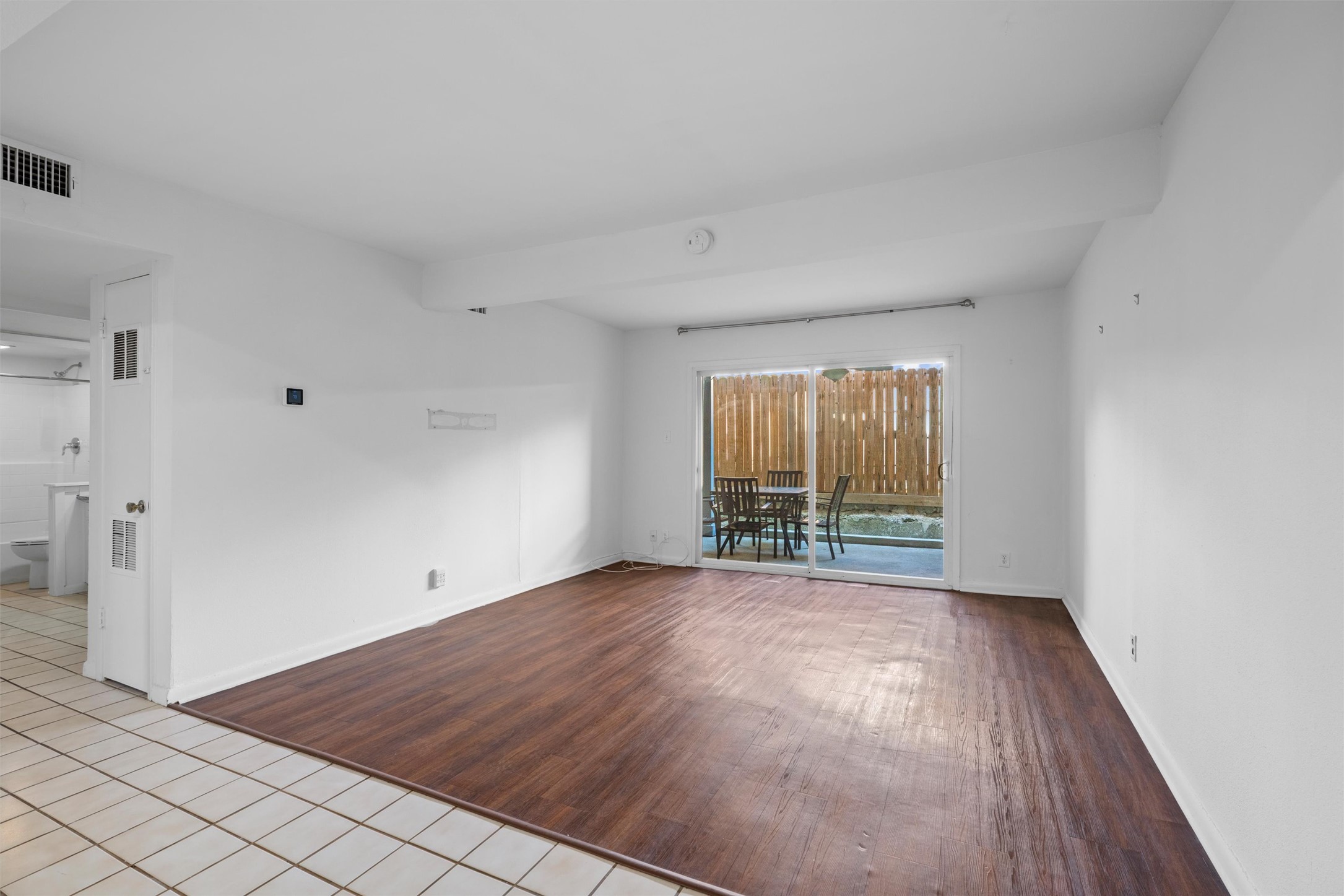 2208 Enfield Road, Unit 10500 Austin, TX 78703 - Photo 9 of 34 Spacious room with wood-finish flooring and a large sliding glass door