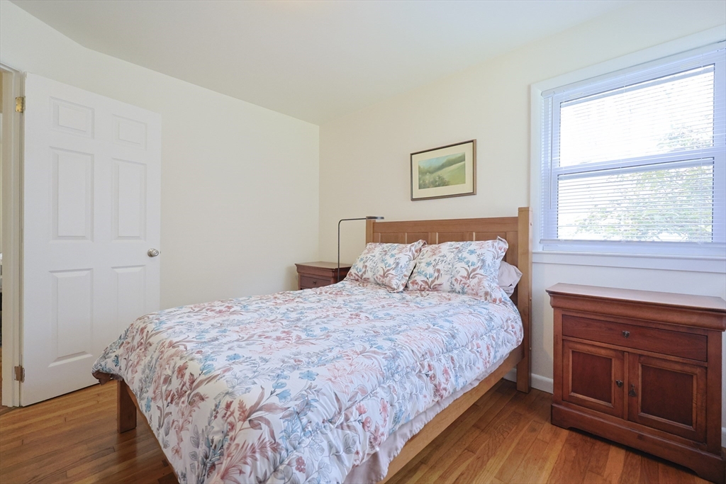 16 East New Lenox Road Lenox, MA 01240 - Photo 19 of 29 a bedroom with a bed and wooden floor