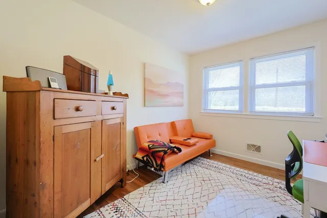 a bedroom with a bed and a dresser