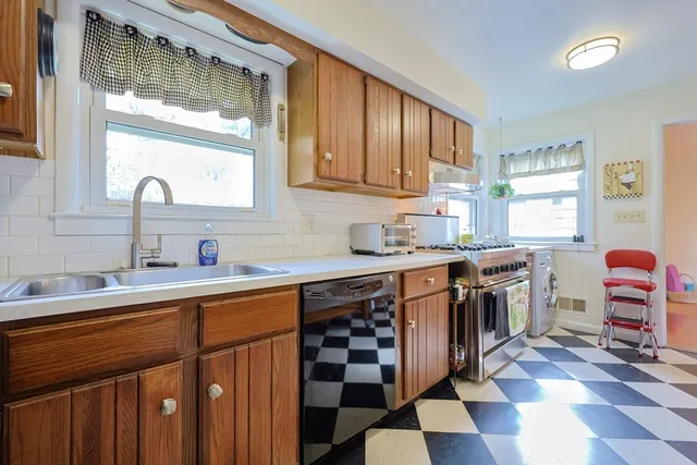 a kitchen with stainless steel appliances a sink stove and cabinets
