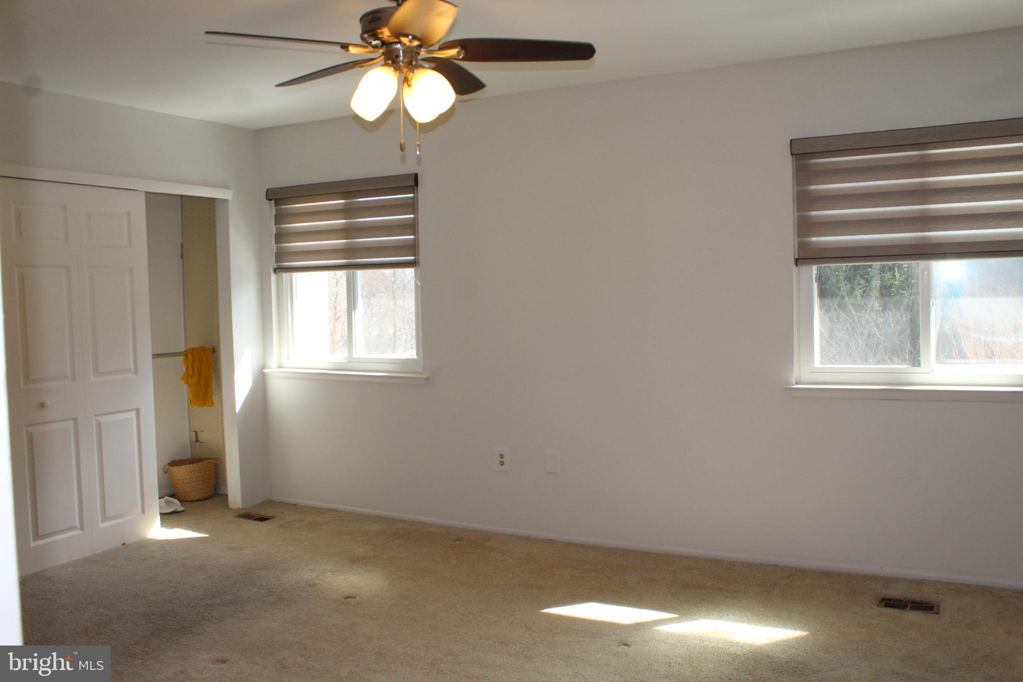 15002 Eardley Court, Unit 282B Silver Spring, MD 20906 - Photo 13 of 28 an empty room with windows and fan