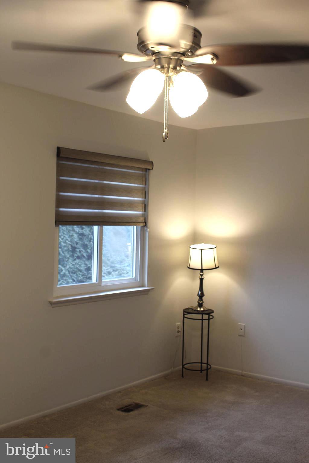 15002 Eardley Court, Unit 282B Silver Spring, MD 20906 - Photo 14 of 28 a view of a room with a chandelier fan and windows