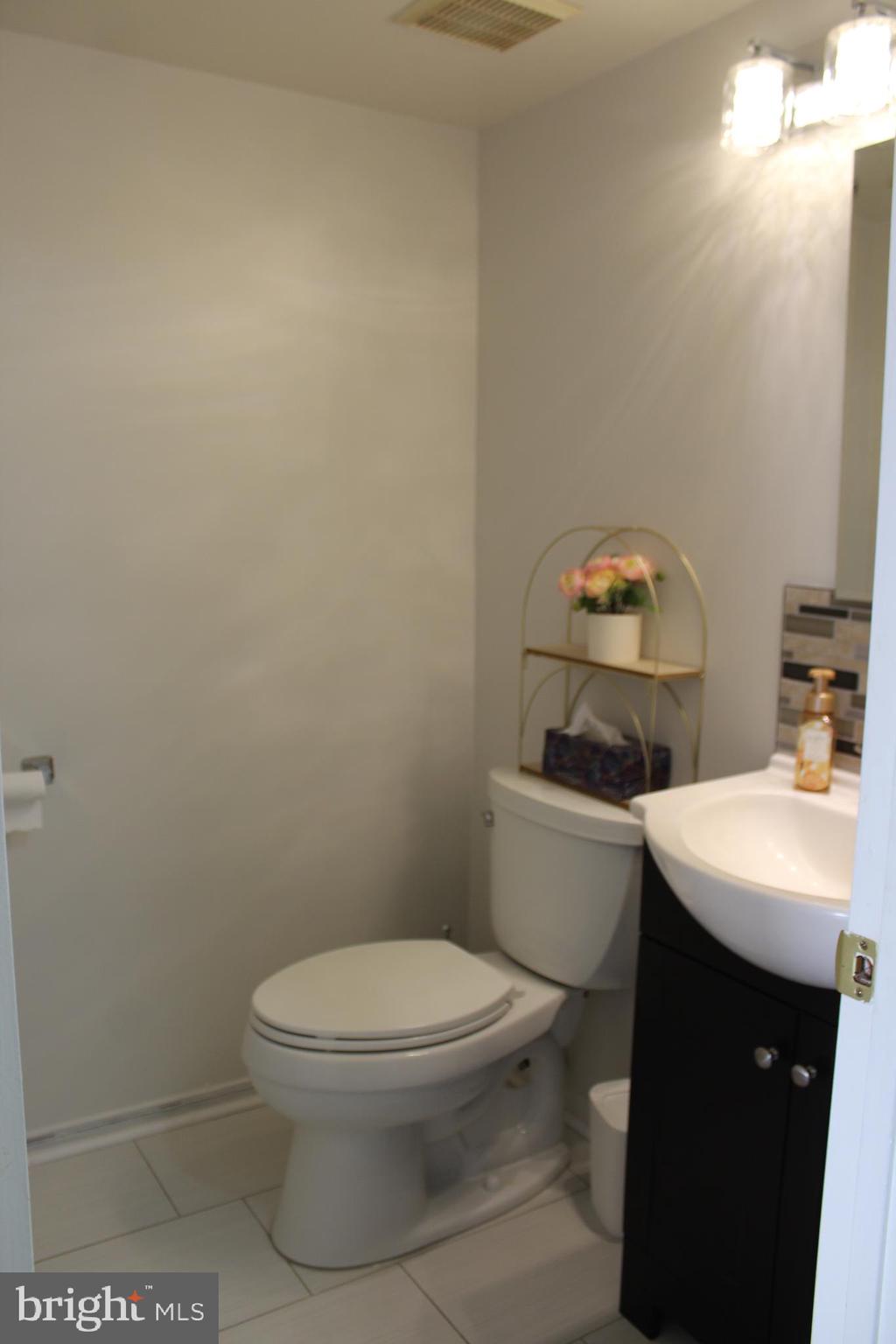 15002 Eardley Court, Unit 282B Silver Spring, MD 20906 - Photo 25 of 28 a white toilet sitting next to a bathroom sink
