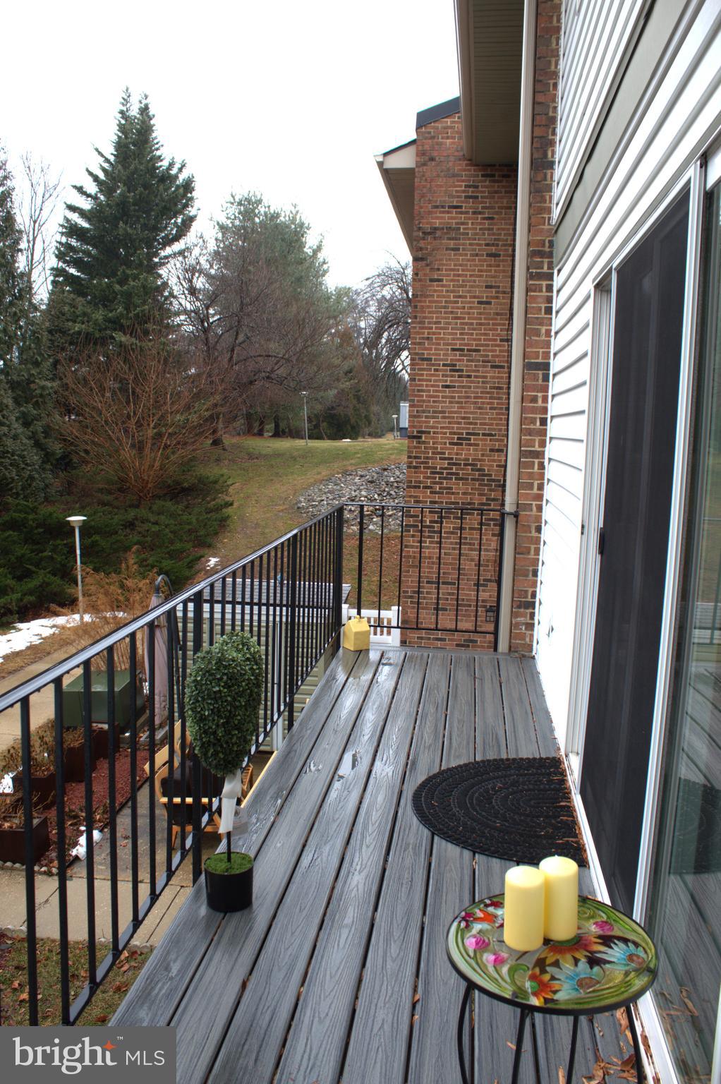 15002 Eardley Court, Unit 282B Silver Spring, MD 20906 - Photo 26 of 28 a view of balcony with wooden floor and outdoor seating