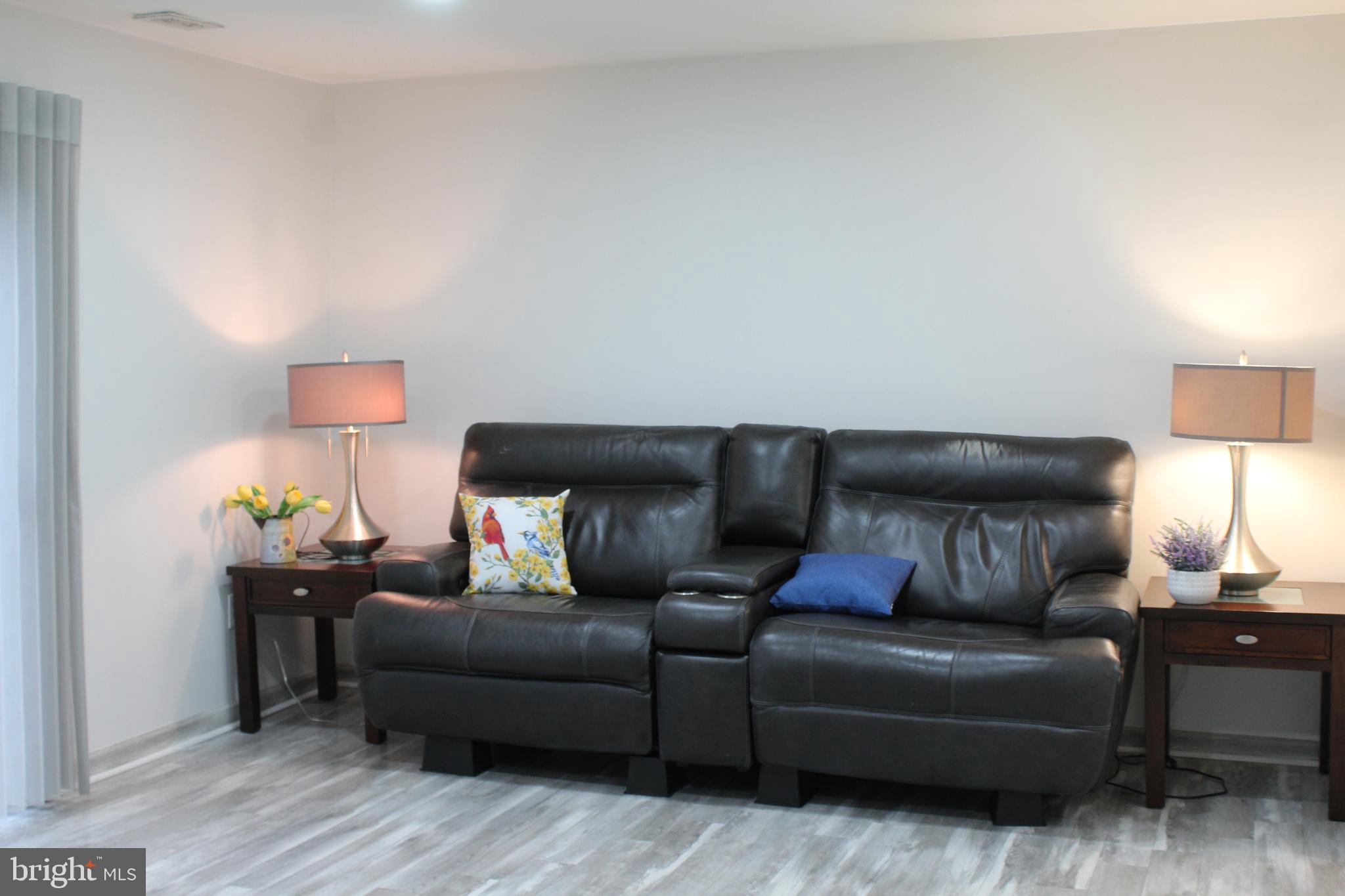 15002 Eardley Court, Unit 282B Silver Spring, MD 20906 - Photo 27 of 28 a living room with furniture and wooden floor
