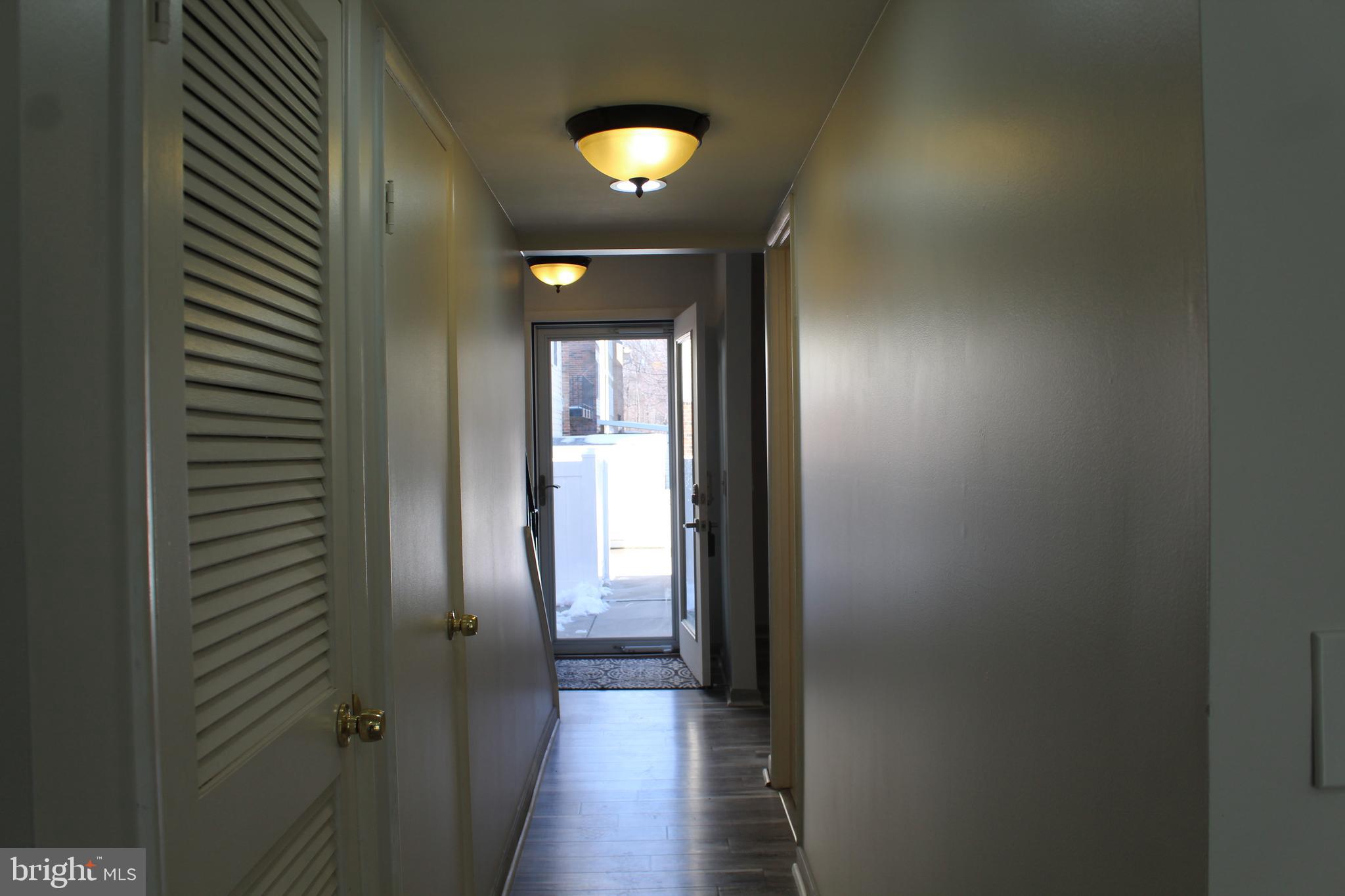 15002 Eardley Court, Unit 282B Silver Spring, MD 20906 - Photo 6 of 28 a view of a hallway with wooden floor and a bathroom