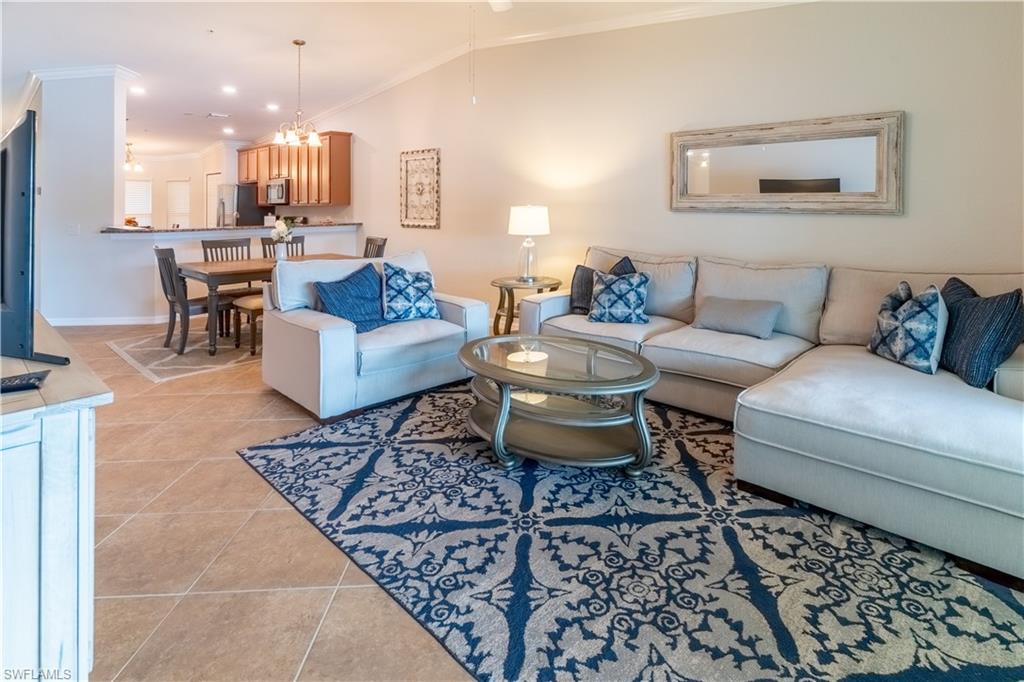 9521 Avellino Way, Unit 2426 Naples, FL 34113 - Photo 1 of 46 a living room with furniture and a rug
