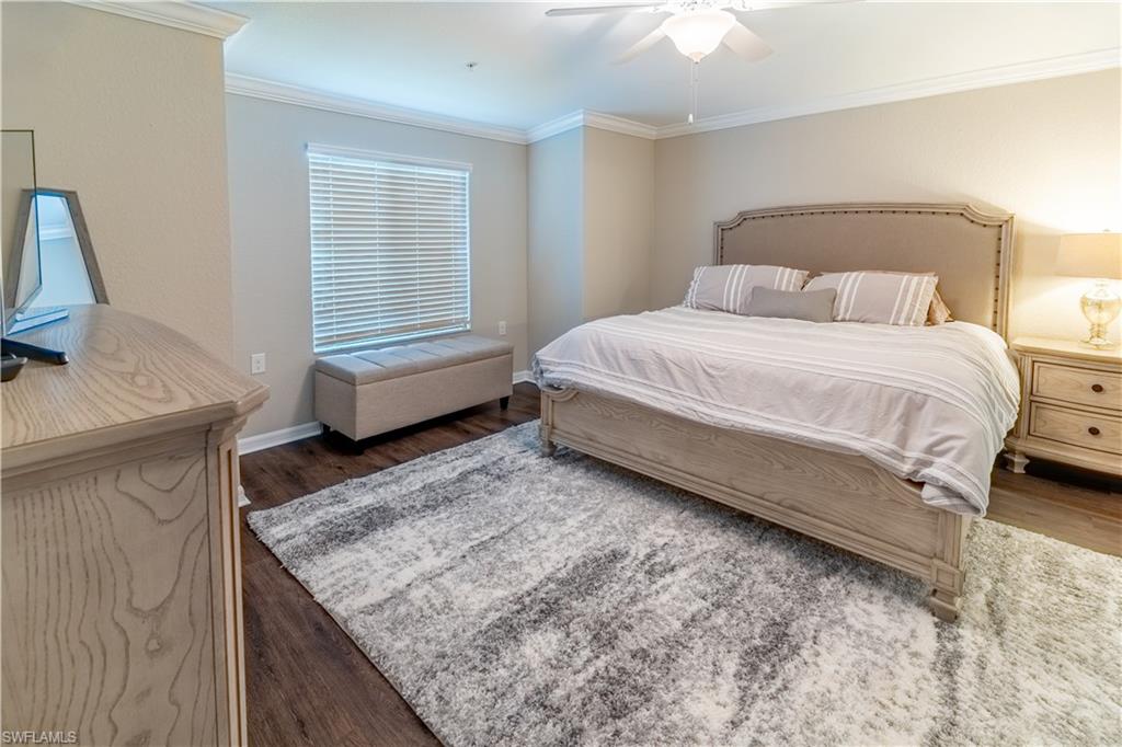 9521 Avellino Way, Unit 2426 Naples, FL 34113 - Photo 20 of 46 a spacious bedroom with a bed and a cabinets