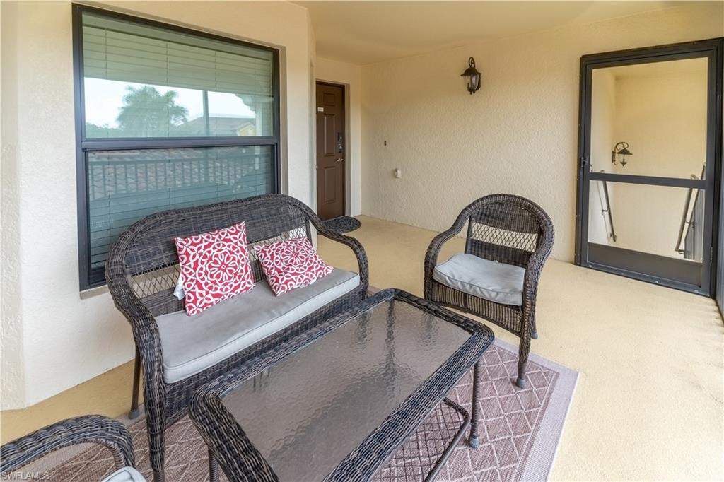 9521 Avellino Way, Unit 2426 Naples, FL 34113 - Photo 24 of 46 a living room with furniture and a window