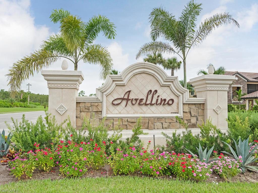 9521 Avellino Way, Unit 2426 Naples, FL 34113 - Photo 27 of 46 a view of a sign board with flower plants and wooden fence