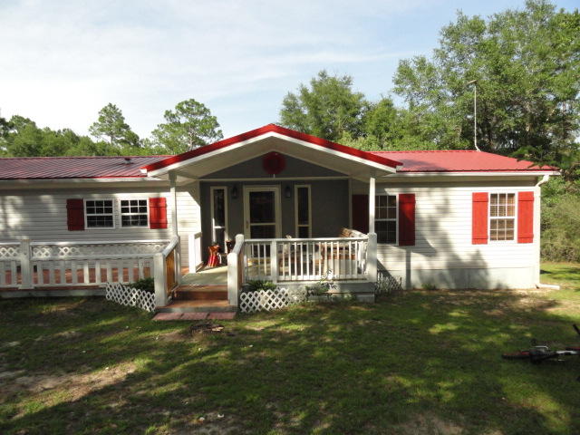 2592 Hinote Road DeFuniak Springs, FL 32433 - Photo 1 of 46 a front view of a house with a garden