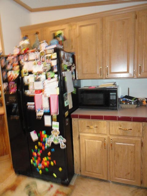 2592 Hinote Road DeFuniak Springs, FL 32433 - Photo 27 of 46 a kitchen with lots of different colored cloths