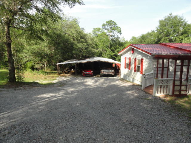 2592 Hinote Road DeFuniak Springs, FL 32433 - Photo 3 of 46 a view of a house with a yard and sitting area