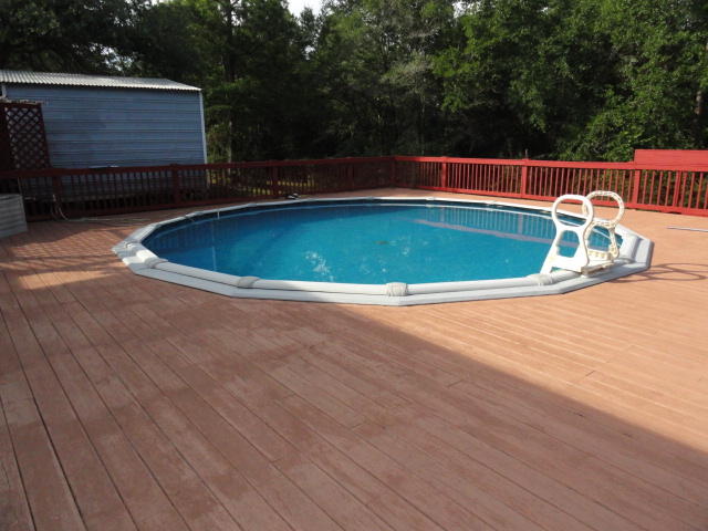 2592 Hinote Road DeFuniak Springs, FL 32433 - Photo 33 of 46 a view of a swimming pool with a yard