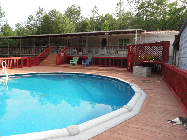2592 Hinote Road DeFuniak Springs, FL 32433 - Photo 36 of 46 a view of a swimming pool with a patio