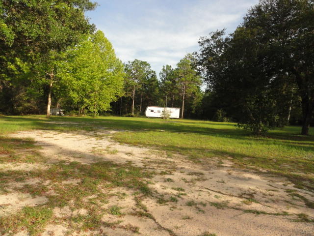 2592 Hinote Road DeFuniak Springs, FL 32433 - Photo 44 of 46 a view of a field with trees in the background