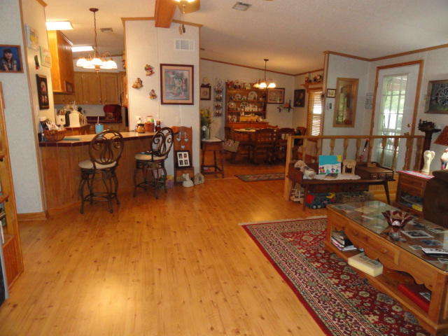 2592 Hinote Road DeFuniak Springs, FL 32433 - Photo 10 of 46 a living room with lots of furniture and painting on the wall