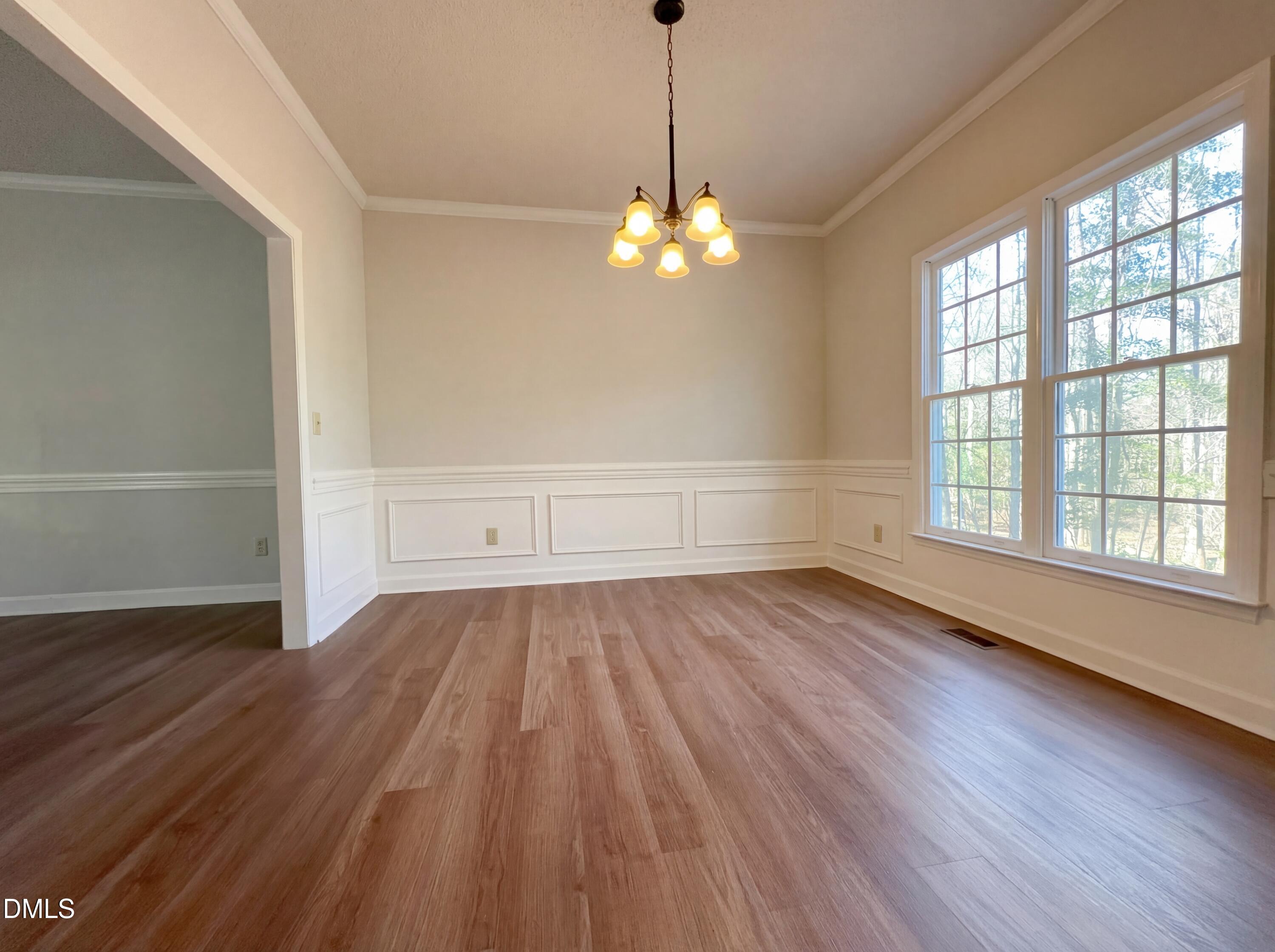 3117 Twatchman Drive Raleigh, NC 27616 - Photo 15 of 27 a view of wooden floor and chandelier in a room